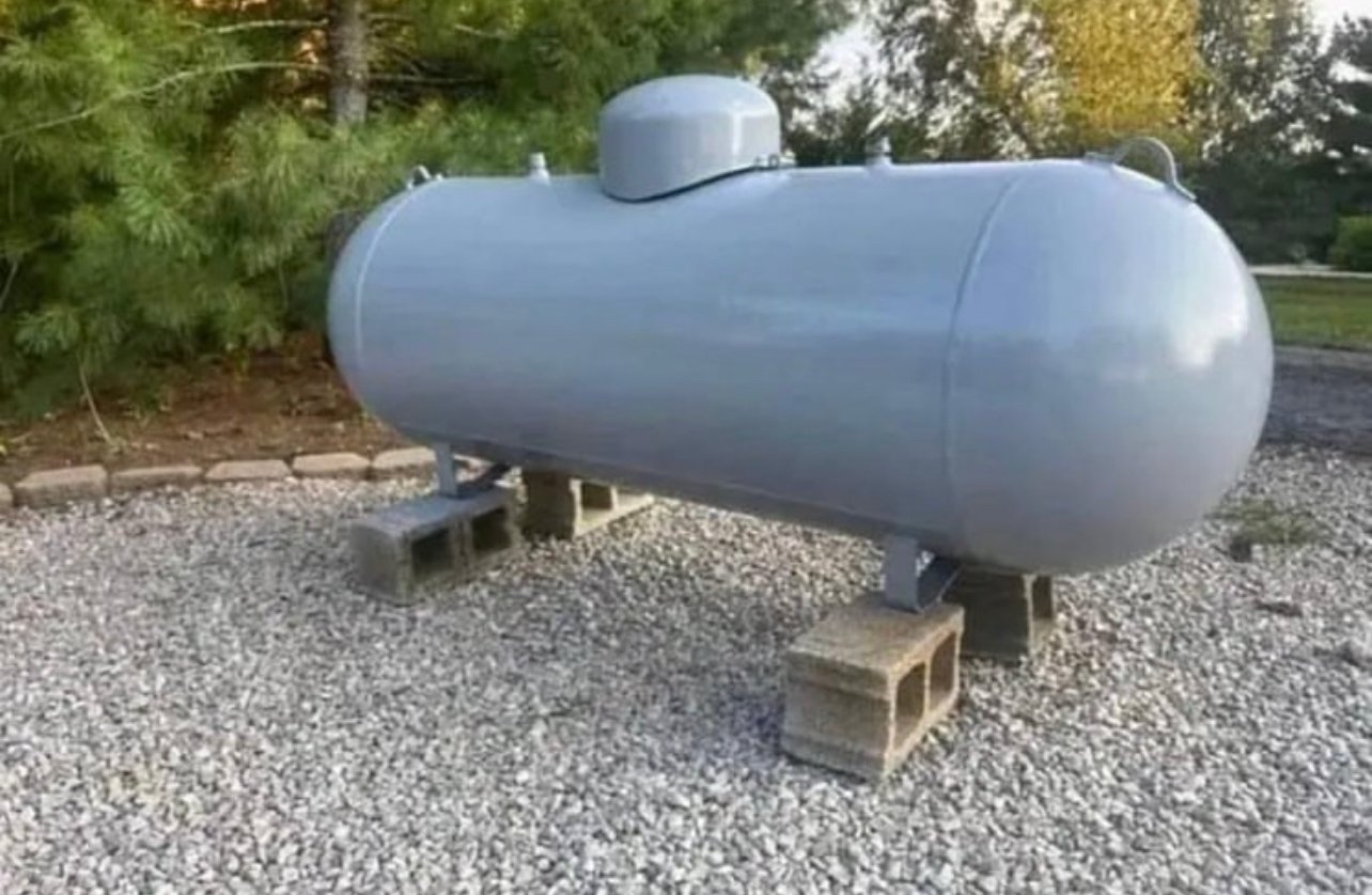 A relevant stock photo of 250 gallon propane tank in a typical setting.