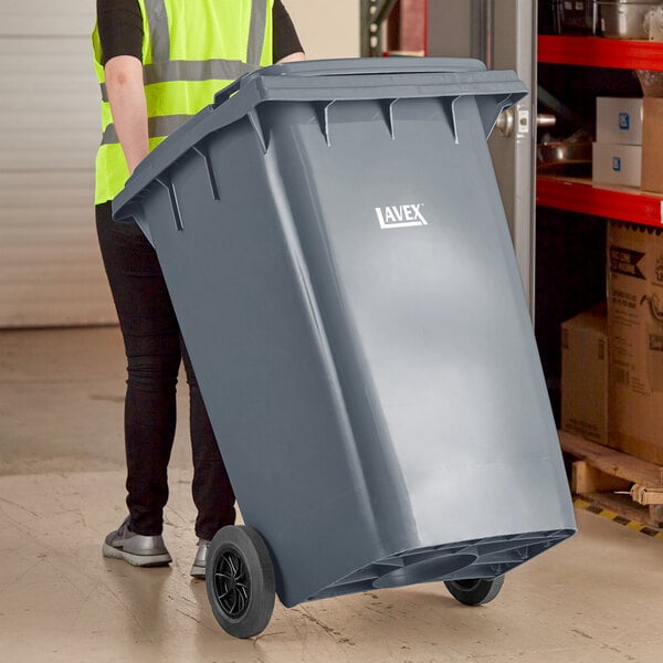 A relevant stock photo of 95 gallon trash can in a typical setting.