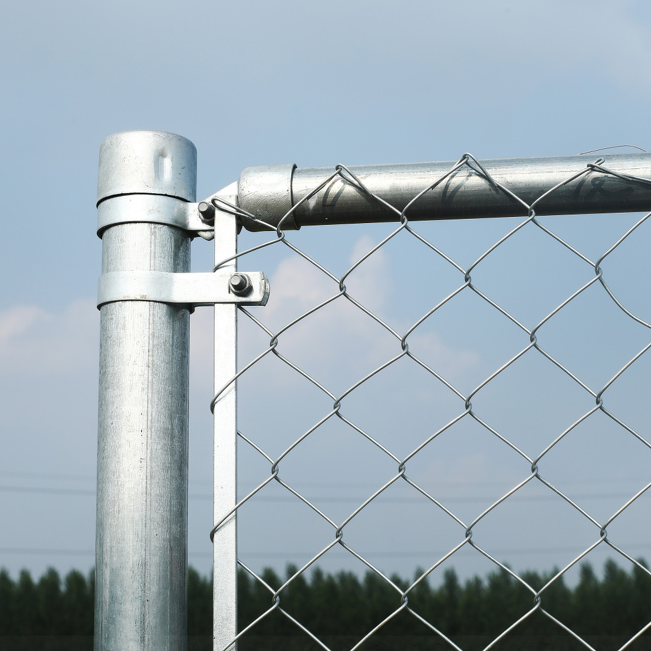 A relevant stock photo of chain link fence post in a typical setting.