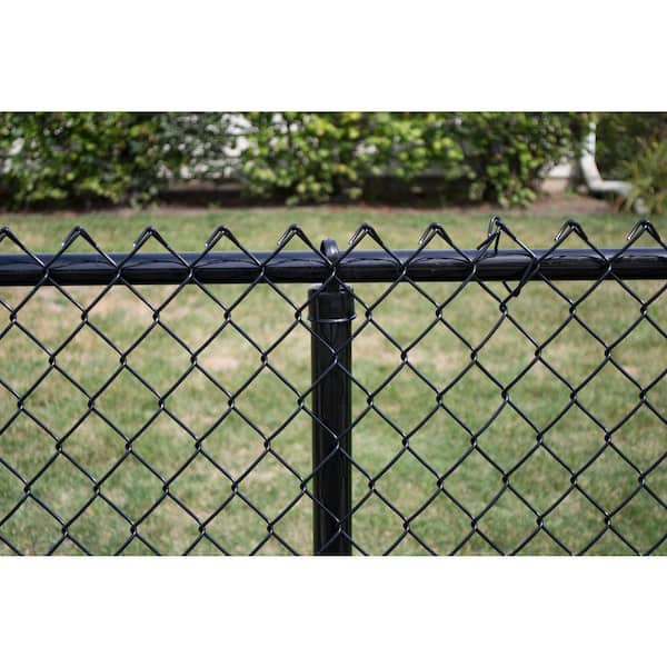 A relevant stock photo of chain link fence post in a typical setting.