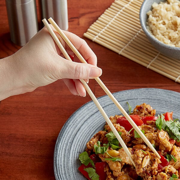 A relevant stock photo of chopsticks for restaurants in a typical setting.