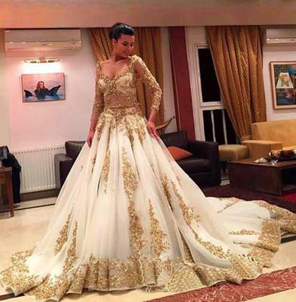 A relevant stock photo of gold wedding dresses in a typical setting.
