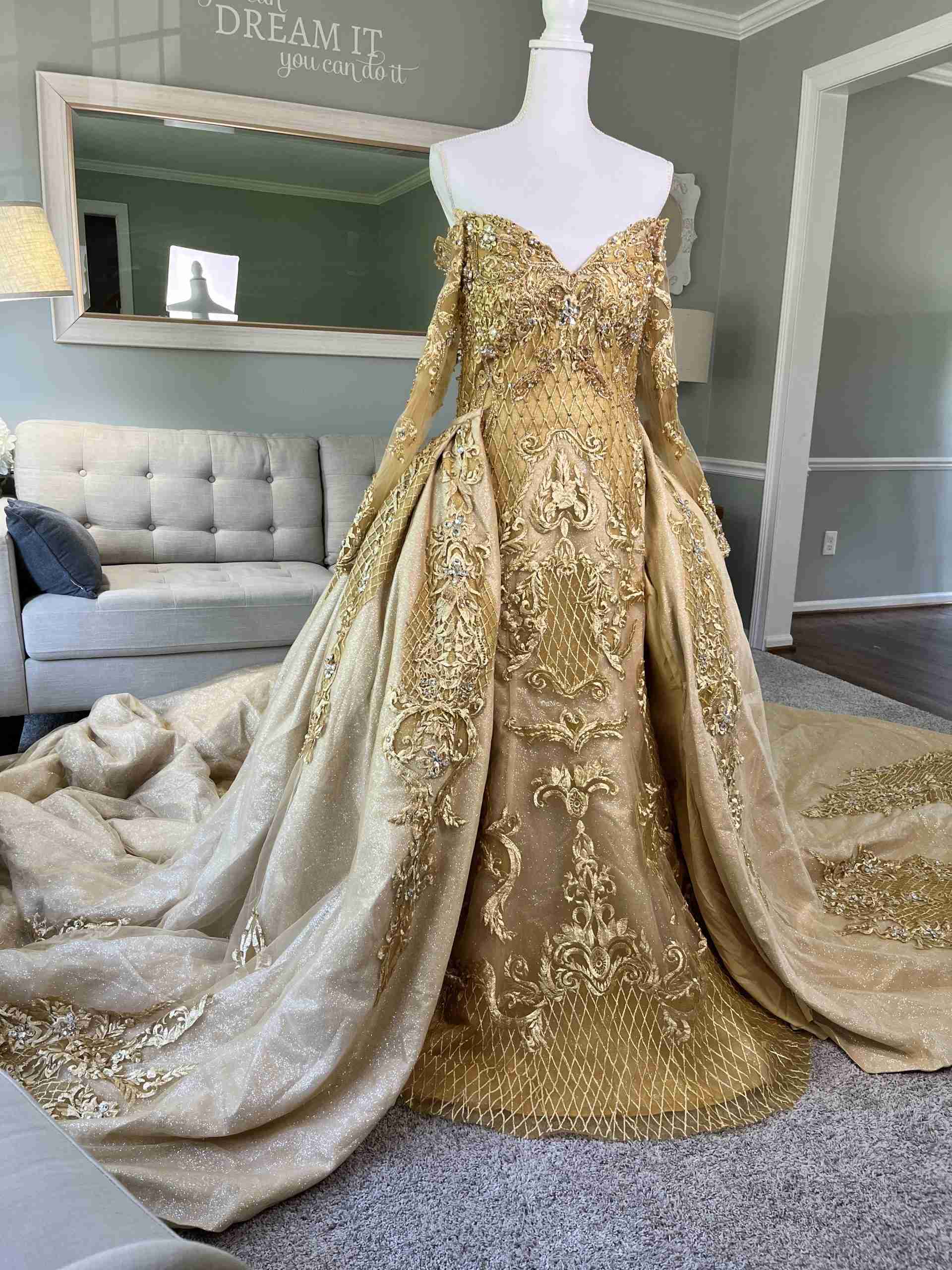 A relevant stock photo of golden colour wedding gown in a typical setting.