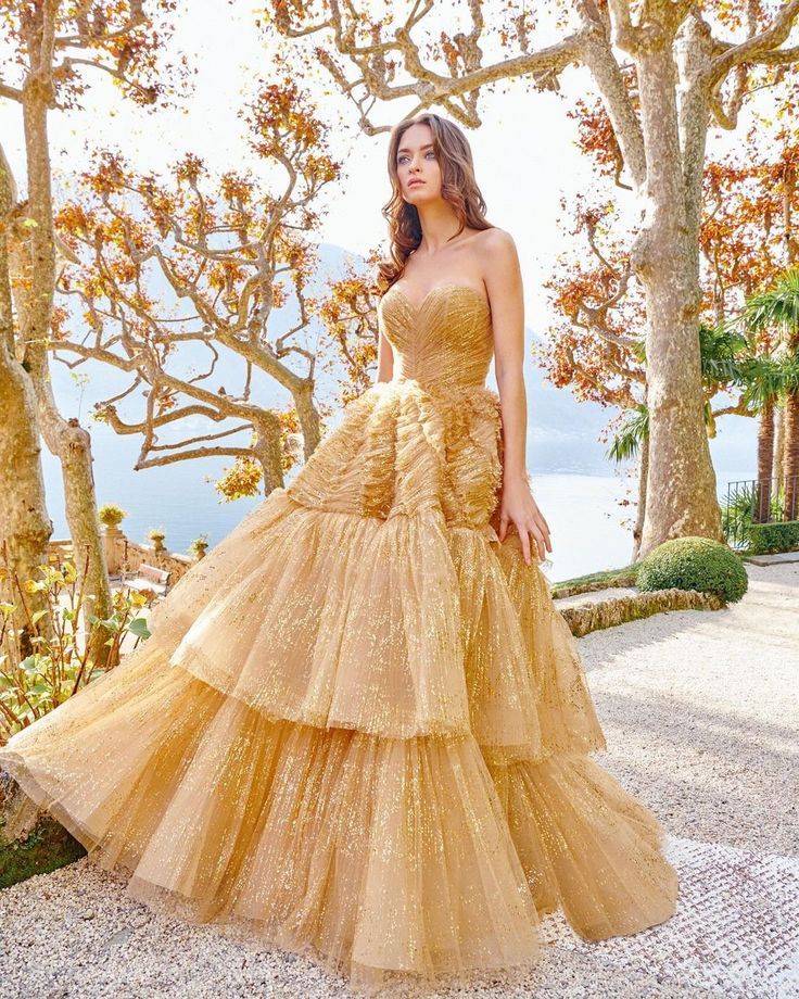 A relevant stock photo of golden colour wedding gown in a typical setting.