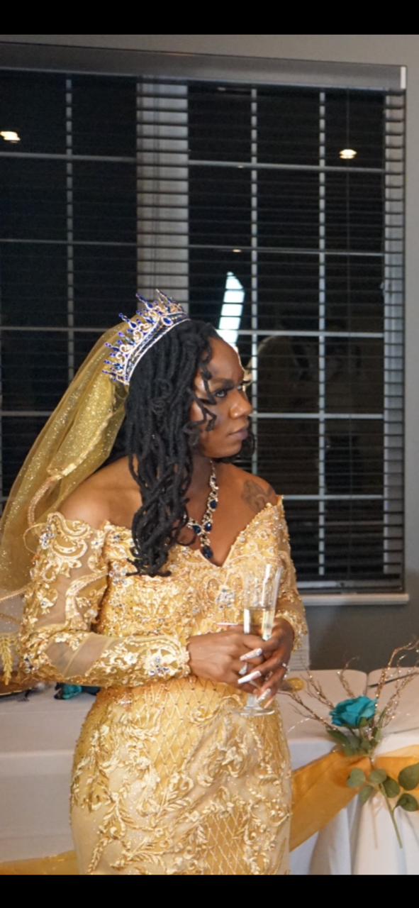 A relevant stock photo of golden colour wedding gown in a typical setting.