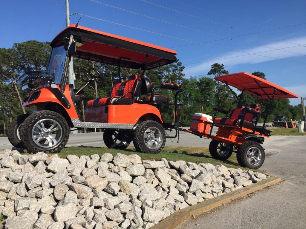 A relevant stock photo of golf cart trailer in a typical setting.