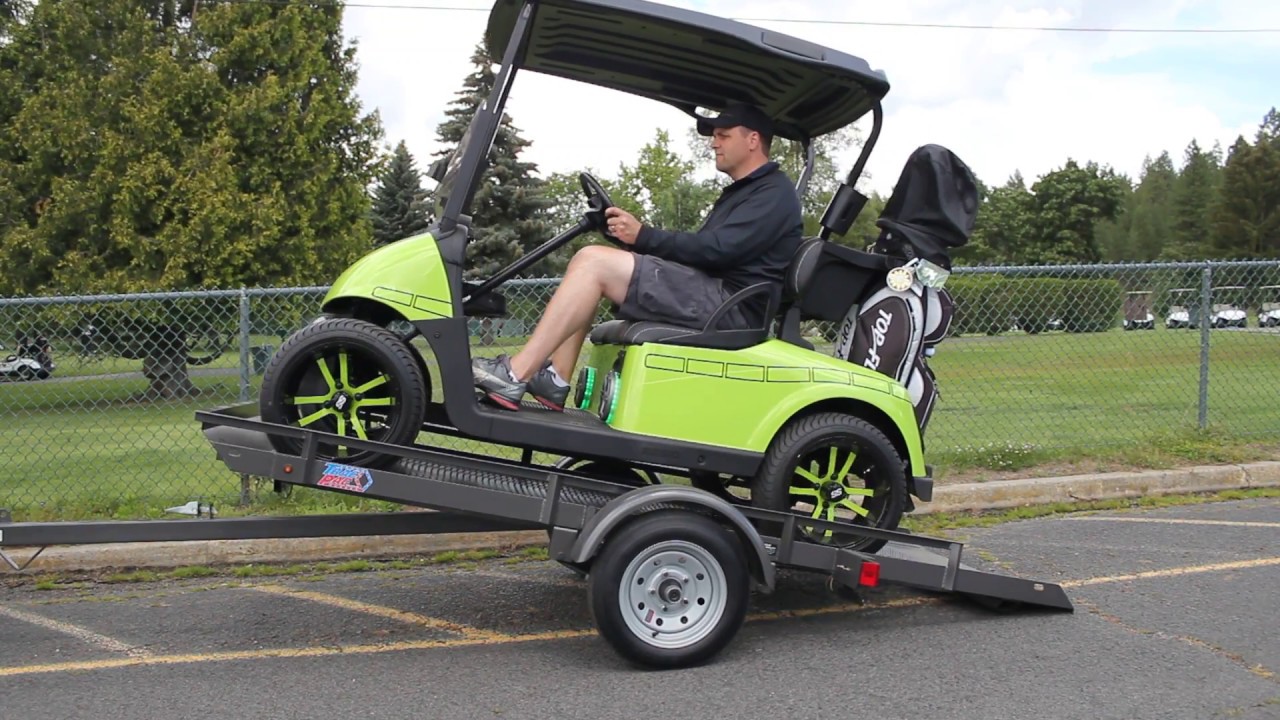 A relevant stock photo of golf cart trailer in a typical setting.