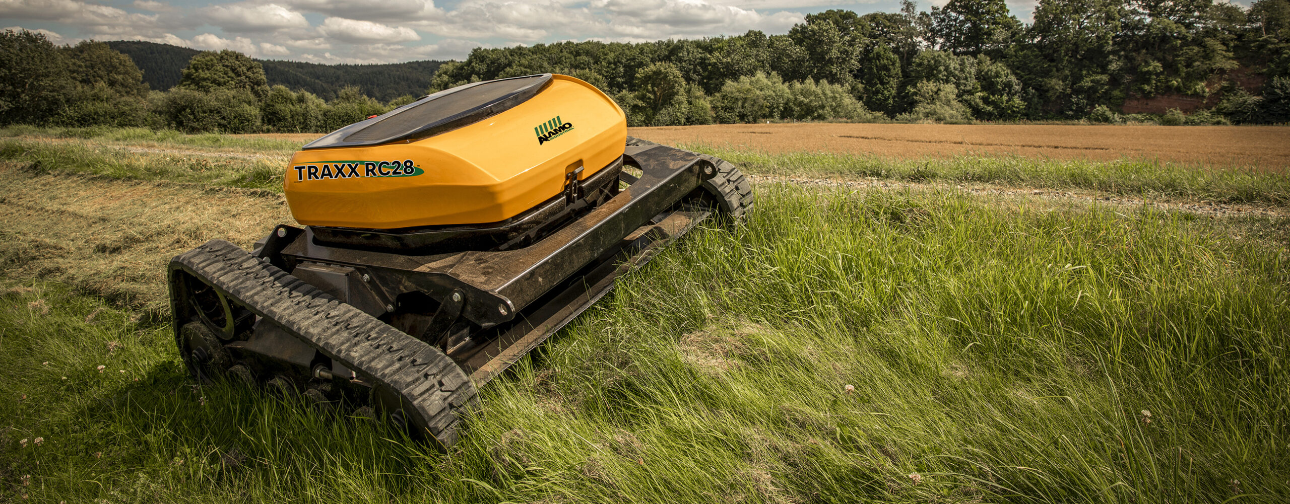 A relevant stock photo of grassland mower in a typical setting.