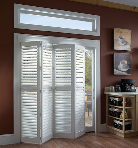A relevant stock photo of plantation shutters for sliding glass doors in a typical setting.