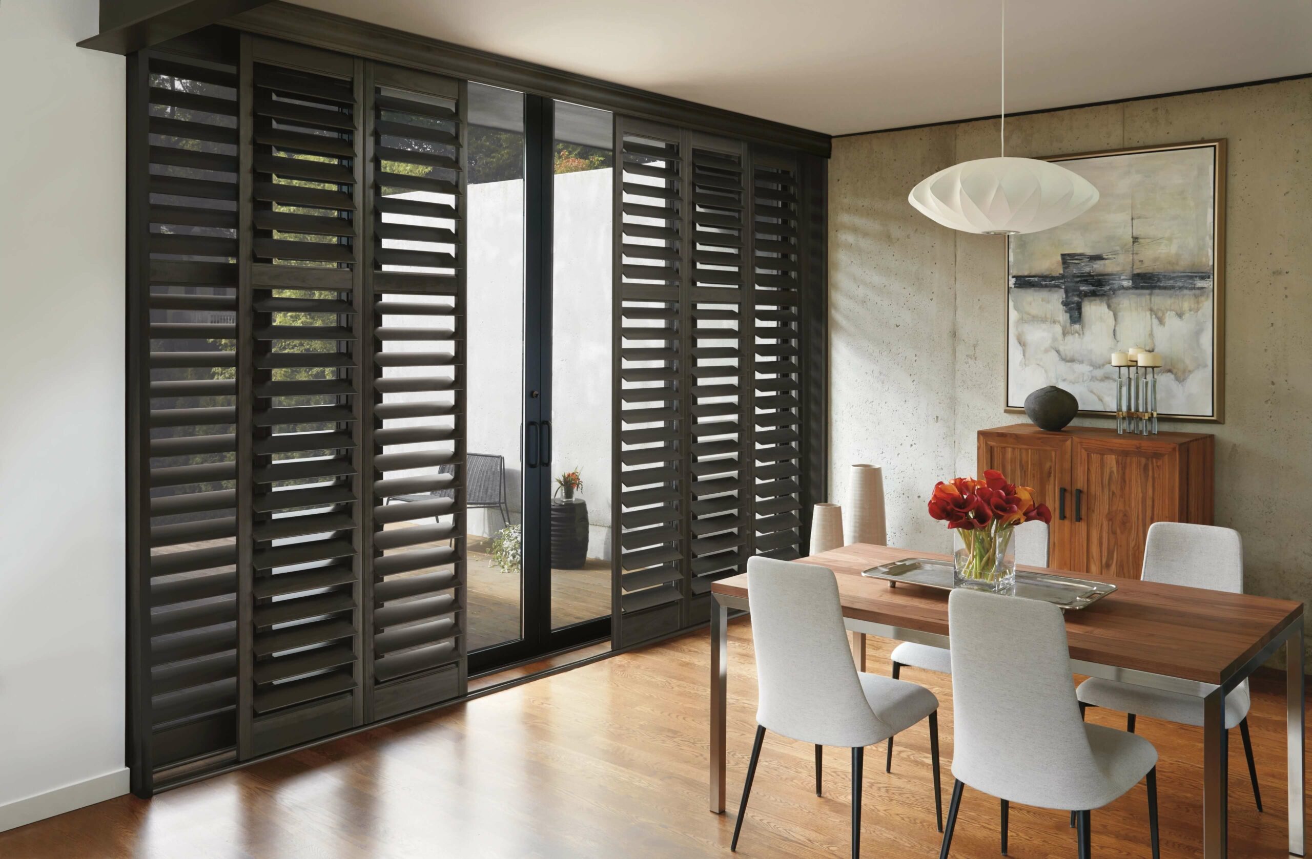 A relevant stock photo of plantation shutters for sliding glass doors in a typical setting.