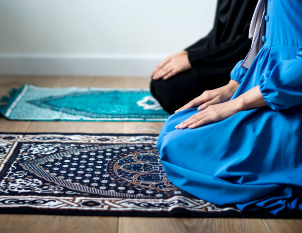 A relevant stock photo of prayer mat praying in a typical setting.