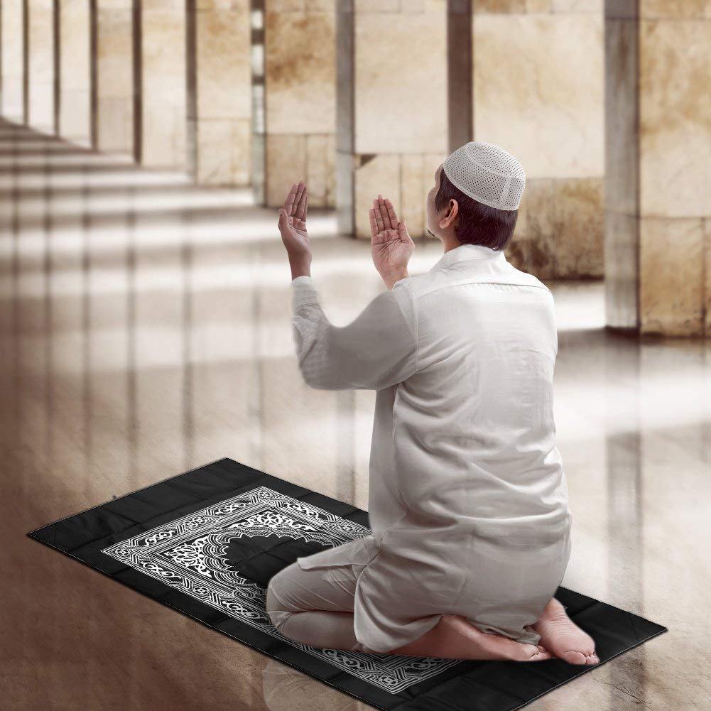 A relevant stock photo of prayer mat praying in a typical setting.