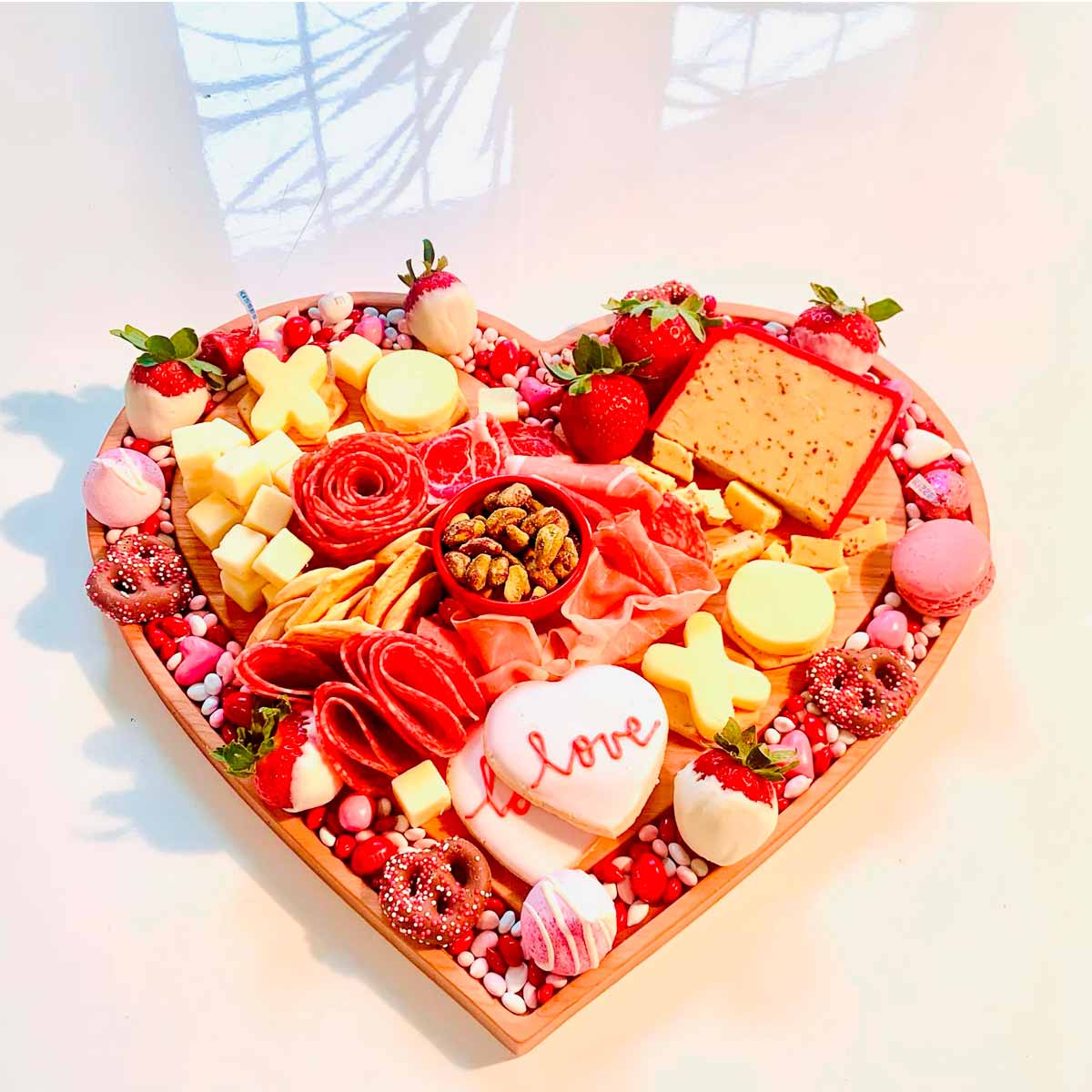 A relevant stock photo of shop heart-shaped charcuterie boards in a typical setting.