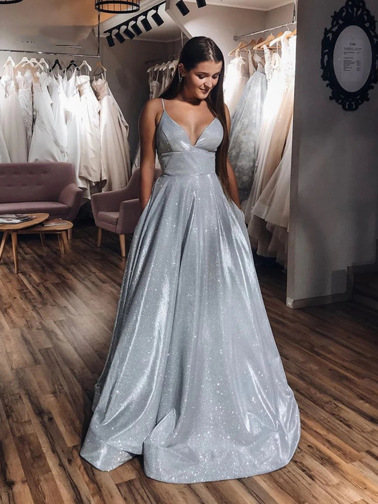 A relevant stock photo of silver gray prom dresses in a typical setting.
