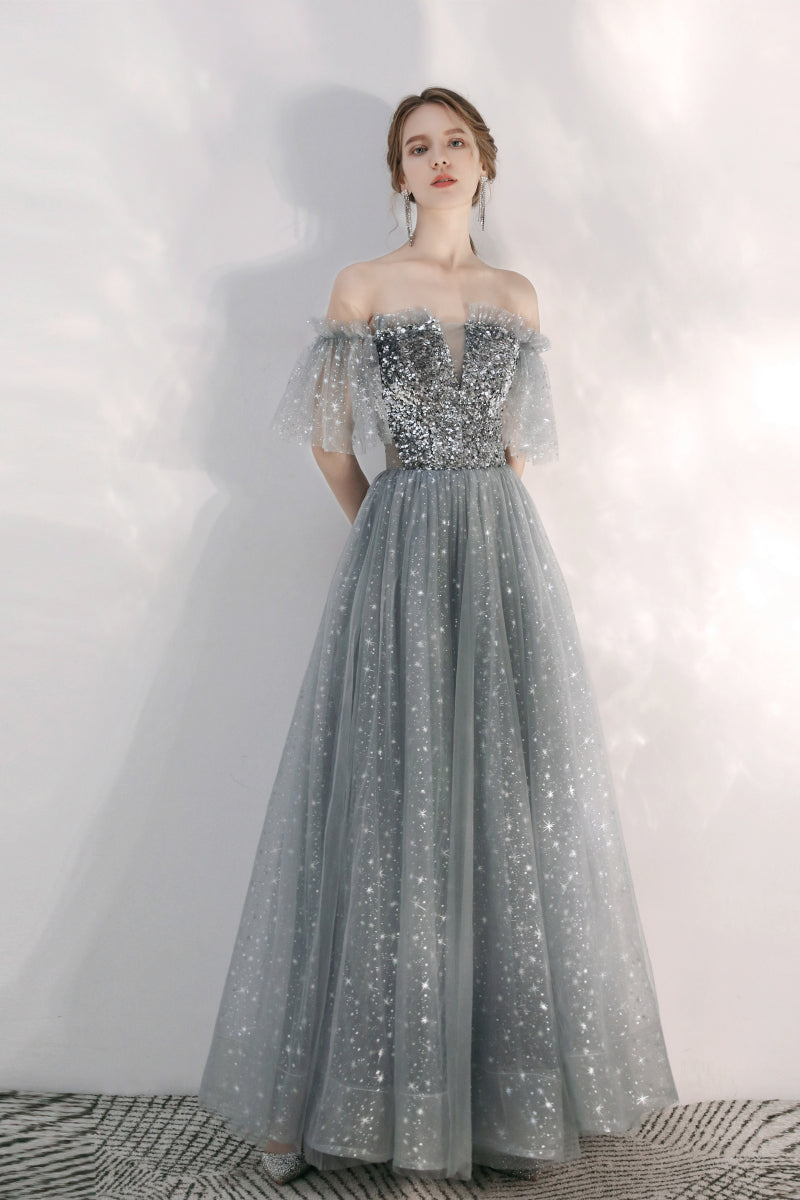A relevant stock photo of silver gray prom dresses in a typical setting.