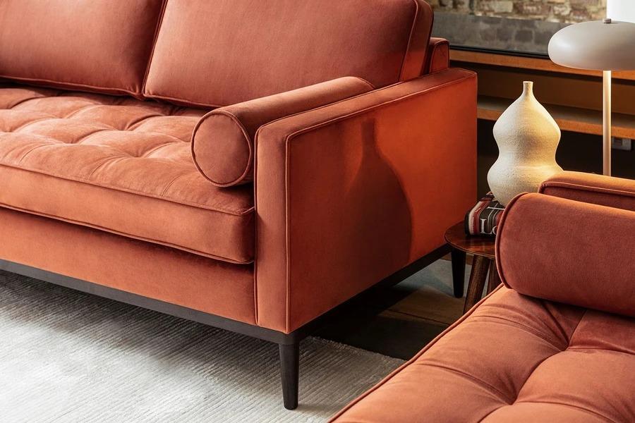 A relevant stock photo of sofa legs in a typical setting.