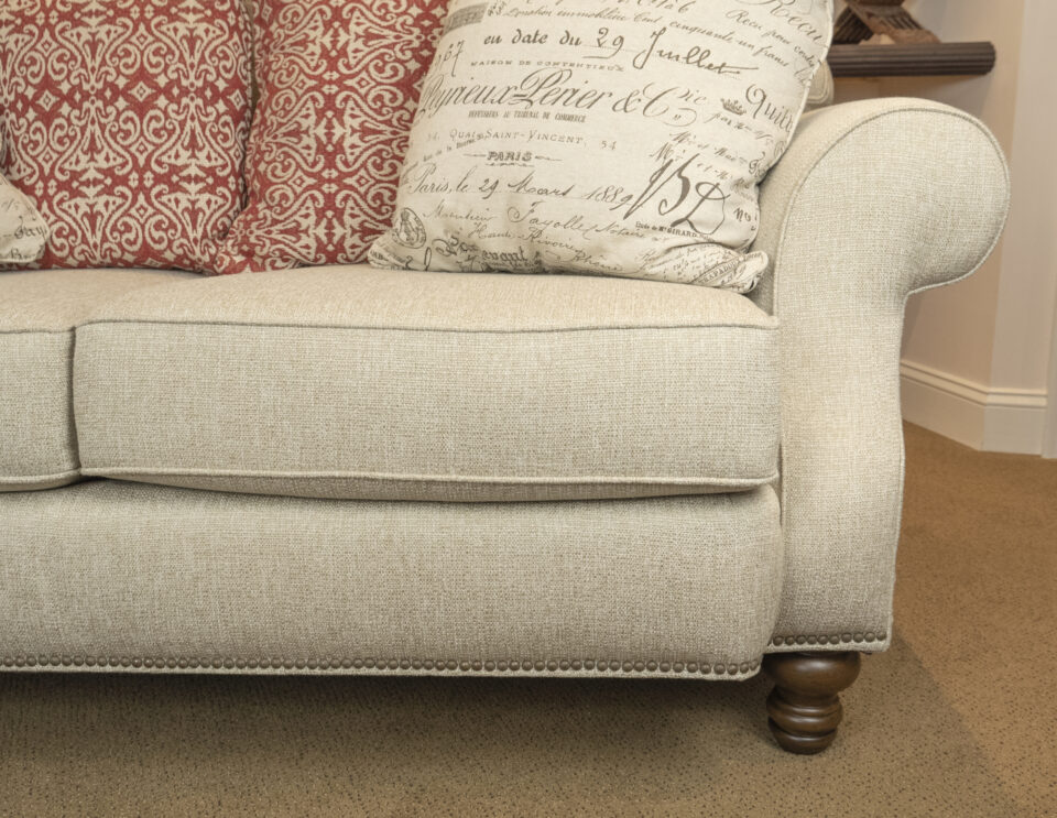 A relevant stock photo of sofa legs in a typical setting.