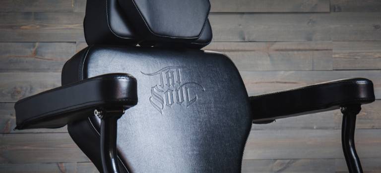 A relevant stock photo of tattoo chair in a typical setting.