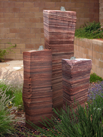 A relevant stock photo of three large sandstone pillars in a typical setting.