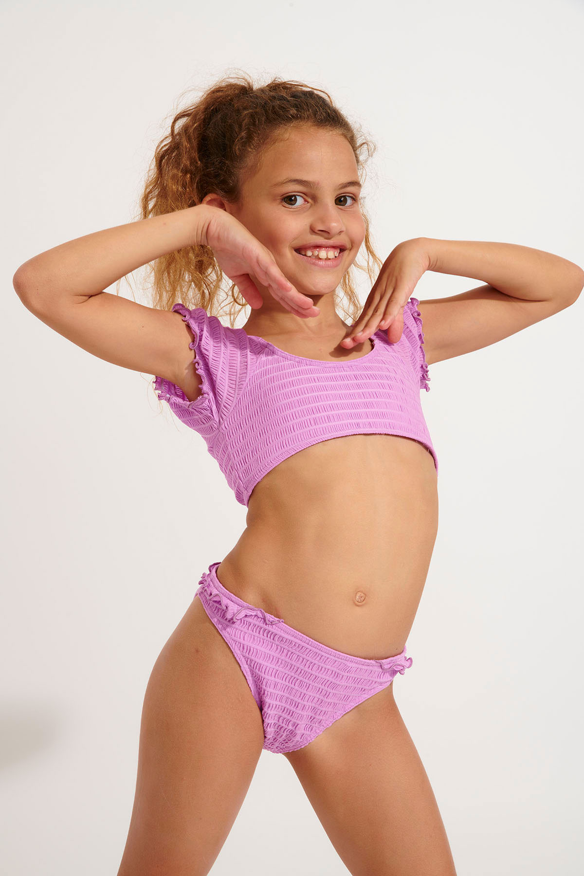 A relevant stock photo of tweens string bathing suits for 12 year olds in a typical setting.