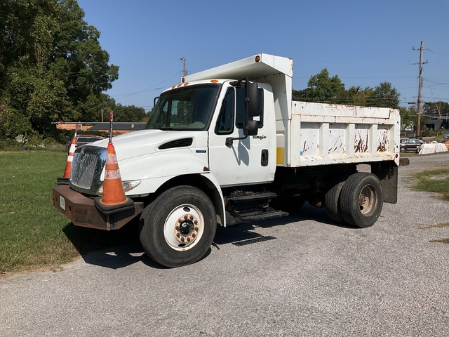 A relevant stock photo of used dump trucks for sale in a typical setting.