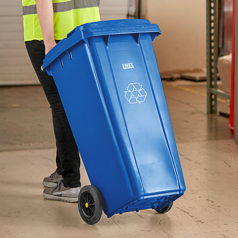 A relevant stock photo of waste container on wheels in a typical setting.